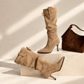 Women's slouchy knee-high boots with pointed toe and buckle